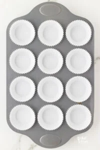 white cupcake liners in a 12-cup standard muffin tin