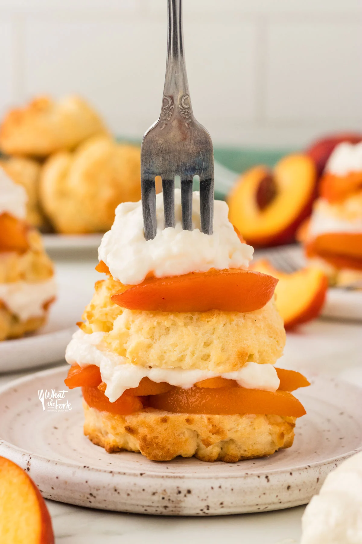 a silver fork pressed into a gluten free peach shortcake