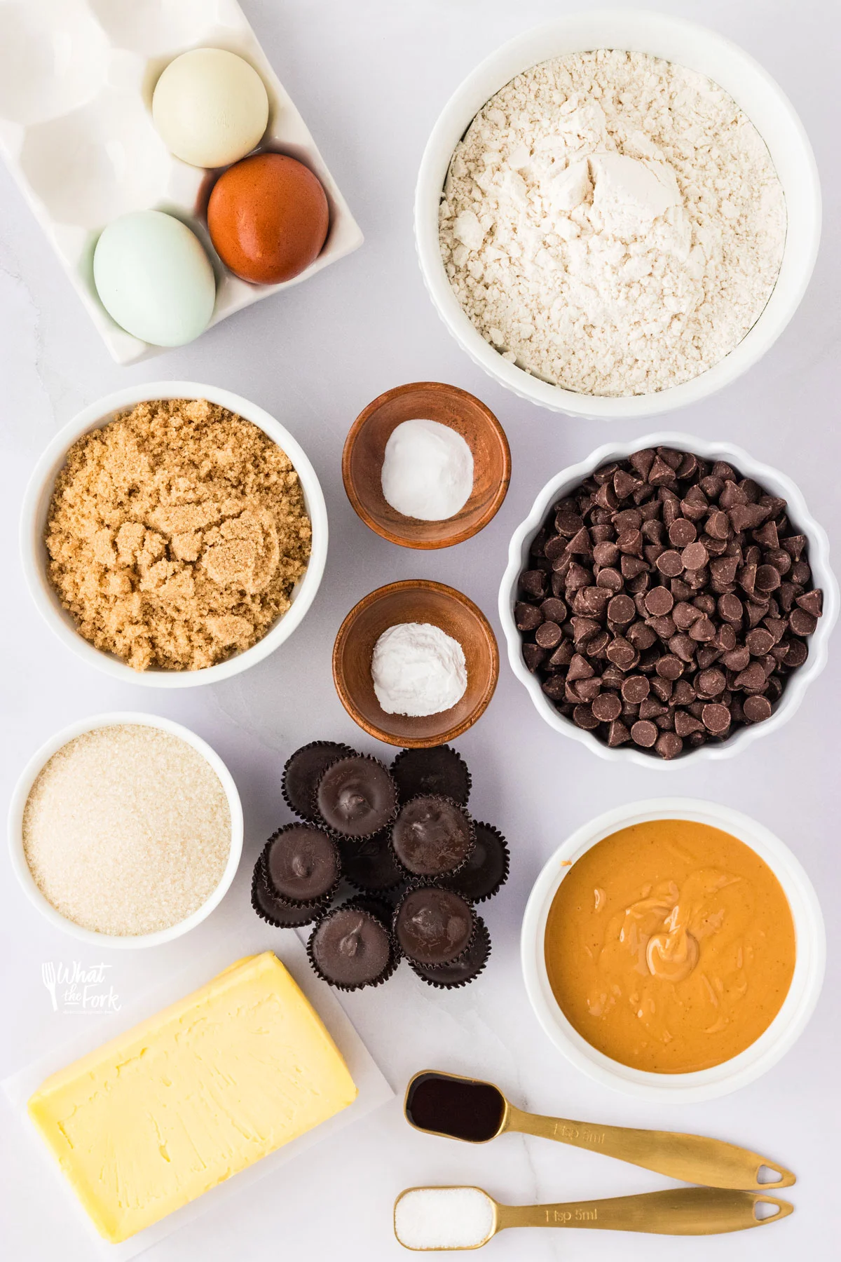 overhead shot of ingredients in individual bowls and measuring spoons to make Loaded Gluten Free Peanut Butter Chocolate Chip Cookies