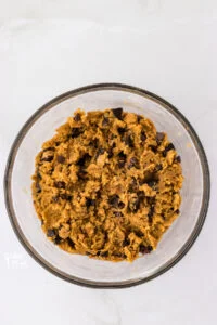 chocolate chips and chopped peanut butter cups mixed into gluten free peanut butter cookie dough