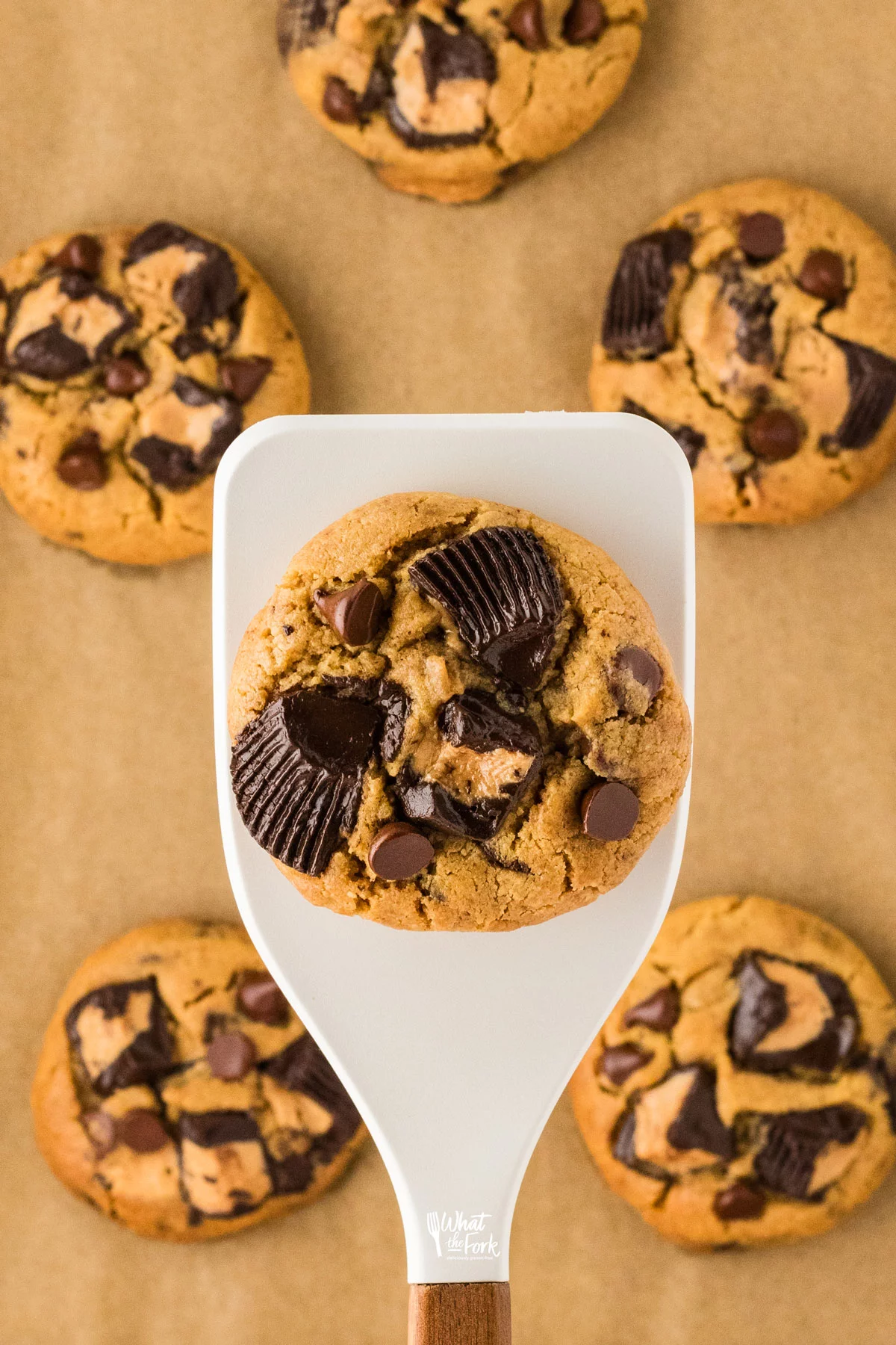 a Loaded Gluten Free Peanut Butter Chocolate Chip Cookie on a white silicone spatula