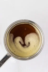 overhead shot of browned butter in a small stainless steel saucepan