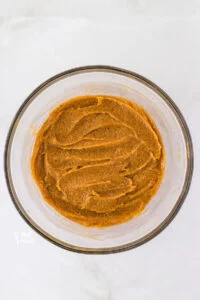 wet ingredients whisked together in a clear glass bowl to make cookies