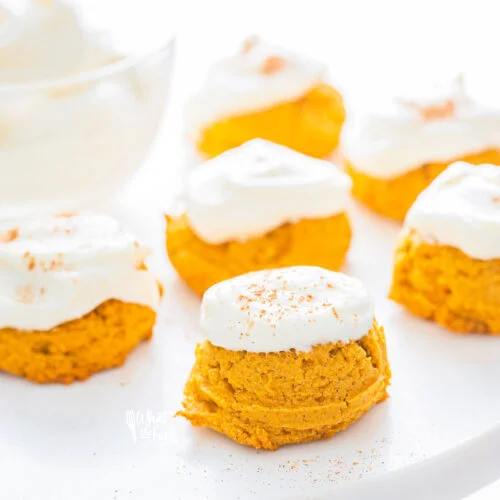 No Chill Gluten Free Pumpkin Cookies with Cream Cheese Frosting dusted with cream cheese and served on a white and wood cake stand