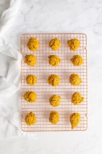 baked pumpkin cookies cooling on a copper wire rack