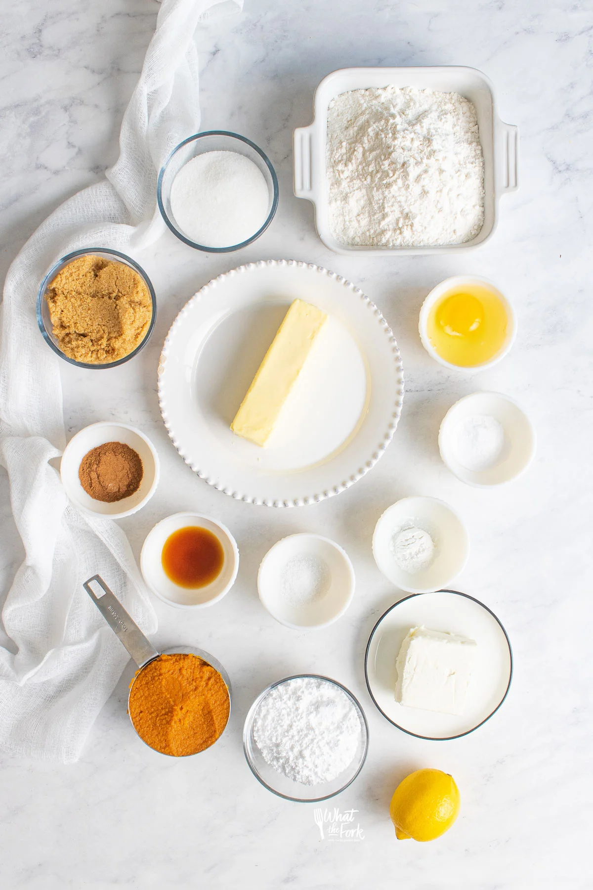 overhead shot of ingredients in individual bowls to make Light as clouds, these Gluten Free Pumpkin Cookies practically melt in your mouth. They have a soft cake-like texture and are topped with velvety cream cheese frosting and a dusting of cinnamon for extra flavor. The cookie dough does not require chilling time so the cookies can be baked and ready to eat in under an hour. Easy gluten free cookie recipe from @whattheforkblog - visit whattheforkfoodblog.com for more gluten free desserts.