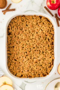 overhead shot of baked gluten free apple crisp in a white 9x13 baking dish