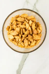 apples, spices, cornstarch, citrus zest, and brown sugar mixed together in a large glass bowl