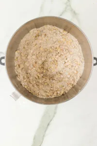 gluten free oats, gluten free flour, spices, and brown sugar in mixed together in a silver stand mixer bowl