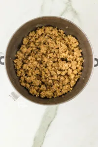 gluten free crisp topping mixed together in a silver stand mixer bowl