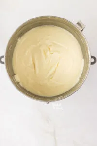 cream cheese mixed with sugar in a silver stand mixer bowl