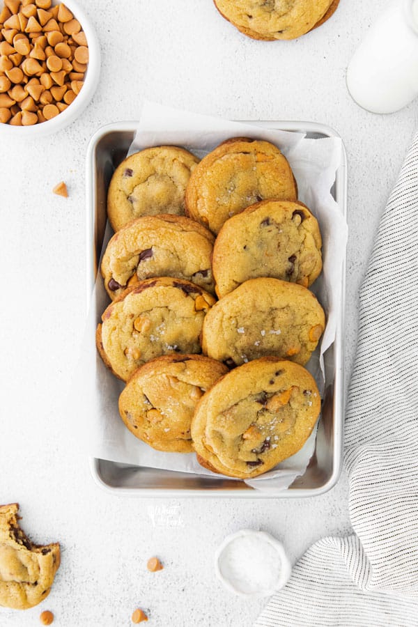 overhead shot of Gluten Free Butterscotch Chocolate Chunk Cookies lined up in a parchment paper lined quarter sheet pan