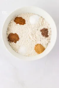 dry ingredients to make gluten free ginger cookies in a small white bowl