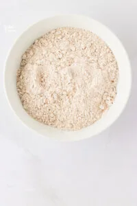 dry ingredients to make gluten free ginger cookies whisked together in a small white bowl