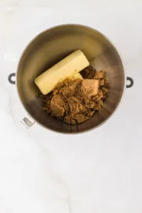 butter and brown sugar in a silver stand mixer bowl
