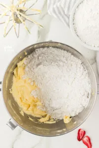 powdered sugar and whipped butter in a silver stand mixer bowl