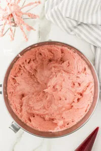 Whipped Strawberry Frosting recipe in a large silver stand mixer bowl