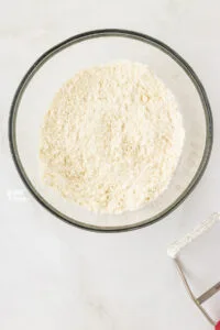 butter cut into the dry ingredients to make gluten free biscuits in a large glass bowl