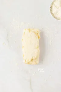 gluten free biscuit dough folded into 3 pieces to laminate the dough