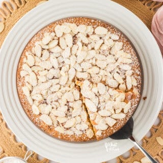 overhead shot of a Gluten Free Almond Flour Cake with a slice cut and being served