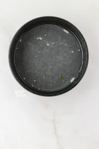 overhead shot of an 8-inch round cake pan prepared for baking a single layer almond flour cake