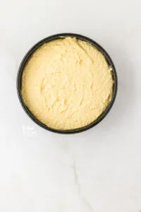 almond flour cake batter in the prepared baking pan ready to be baked.