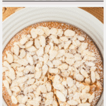Overhead shot of an almond flour cake with one slice cut, ready to be served. Image has text included with color block for Pinterest