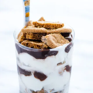 Gluten Free Chocolate Chip Cookie Ice Cream Parfait in a clear glass with a blue and gold spoon handle sticking out