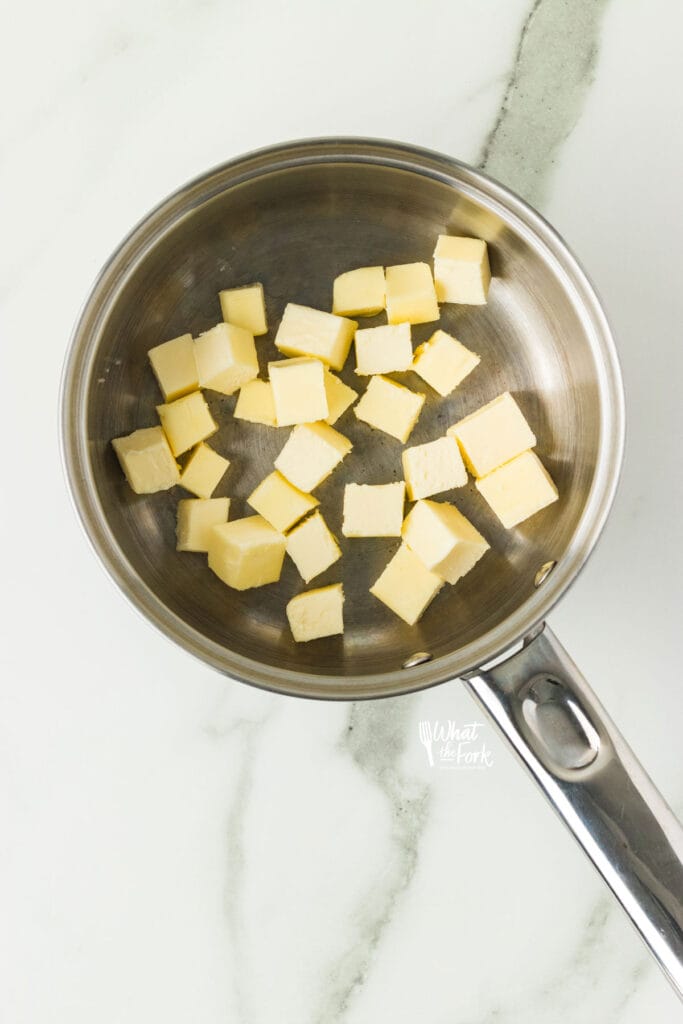 cubed cold butter in a silver pan to make brown butter