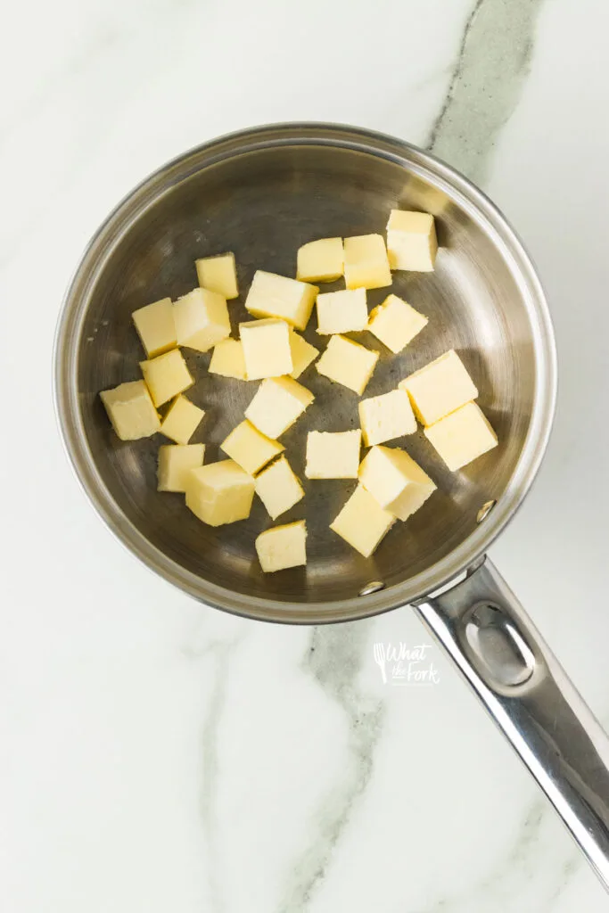 cubed cold butter in a silver pan to make brown butter