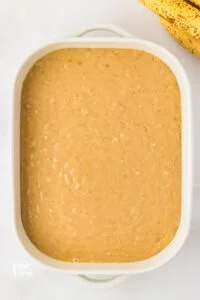 gluten free banana cake batter in a white 9x13 baking pan