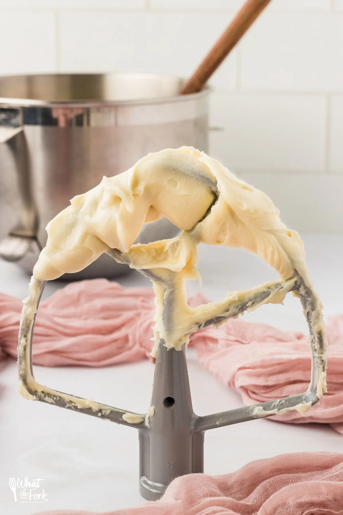 maple cream cheese frosting on a silver KitchenAid Stand Mixer beater