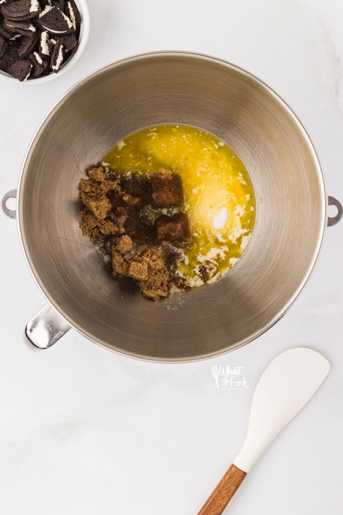 melted butter and sugar in a large silver mixing bowl to make Gluten Free Oreo Chocolate Chip Cookies