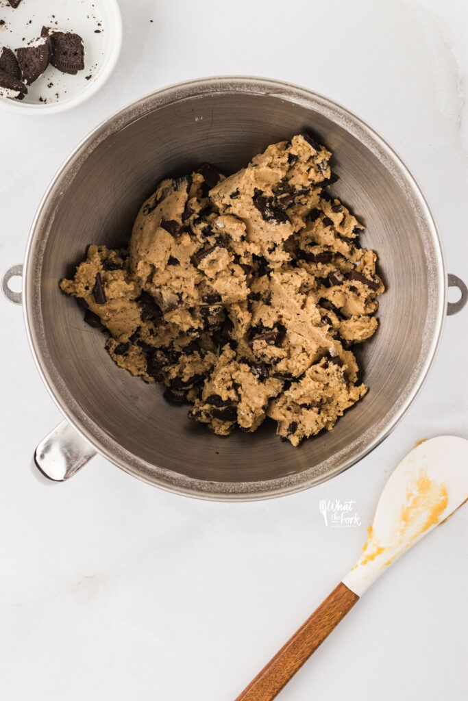Gluten Free Oreo Chocolate Chip Cookie dough in a large silver mixing bowl